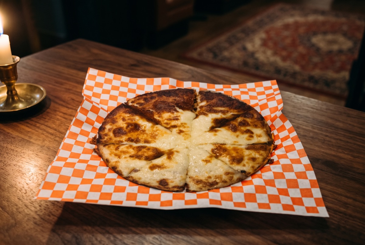 Cheese Pizza · Hand-stretched dough topped with tangy tomato sauce and a generous layer of melted mozzarella, baked until the…