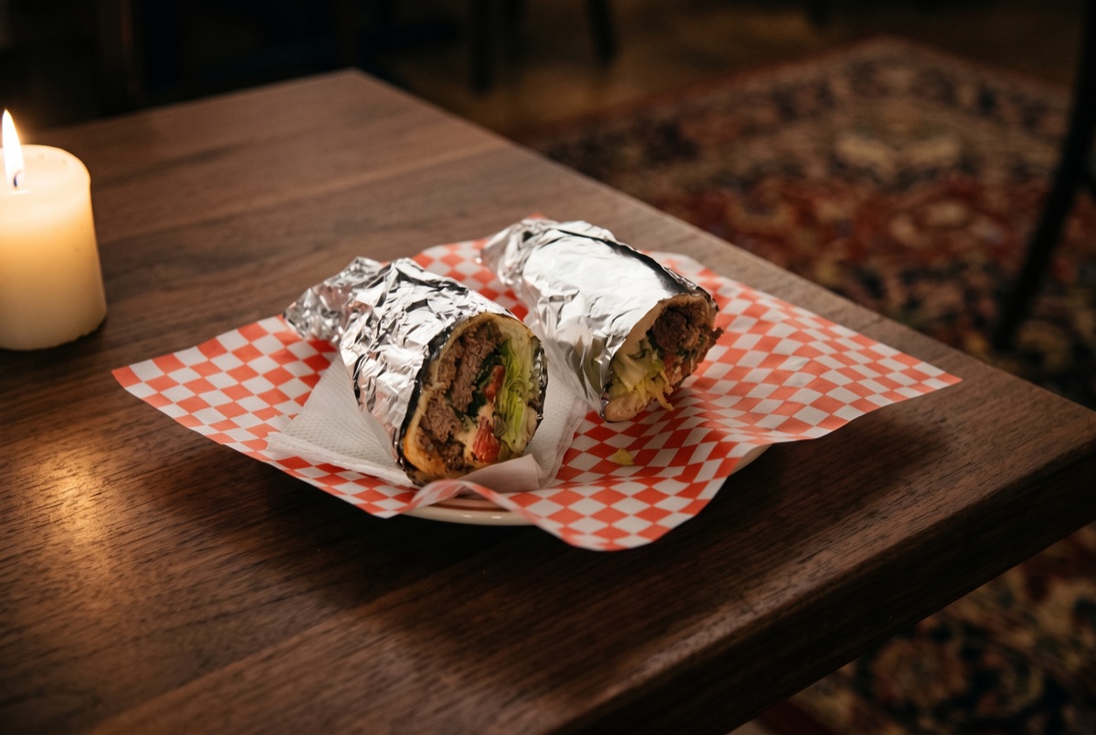 Cheese Burger · A charcoal-grilled beef patty topped with melted cheese, layered on a toasted bun with lettuce, tomato, and onion.