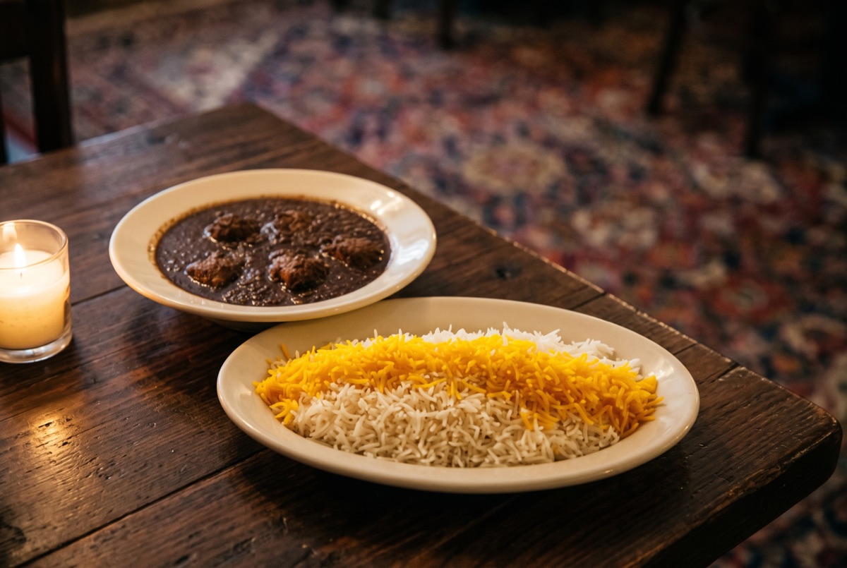 Vegetarian Fessenjoun · Walnut cooked pomegranate sauce mixed with a side of basmati rice. Without Meat