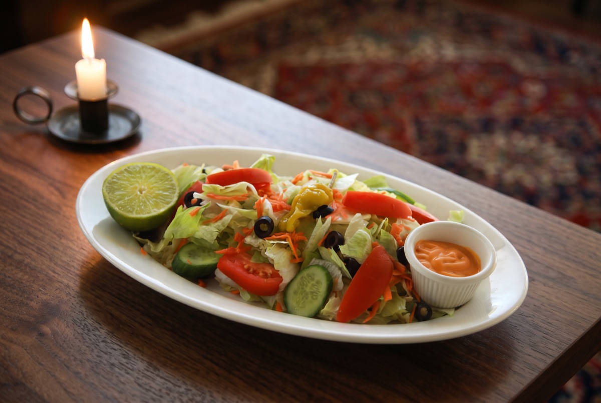 Garden Salad · Crisp mixed greens tossed with cucumber, tomato, and onion, a simple, refreshing salad served alongside the…