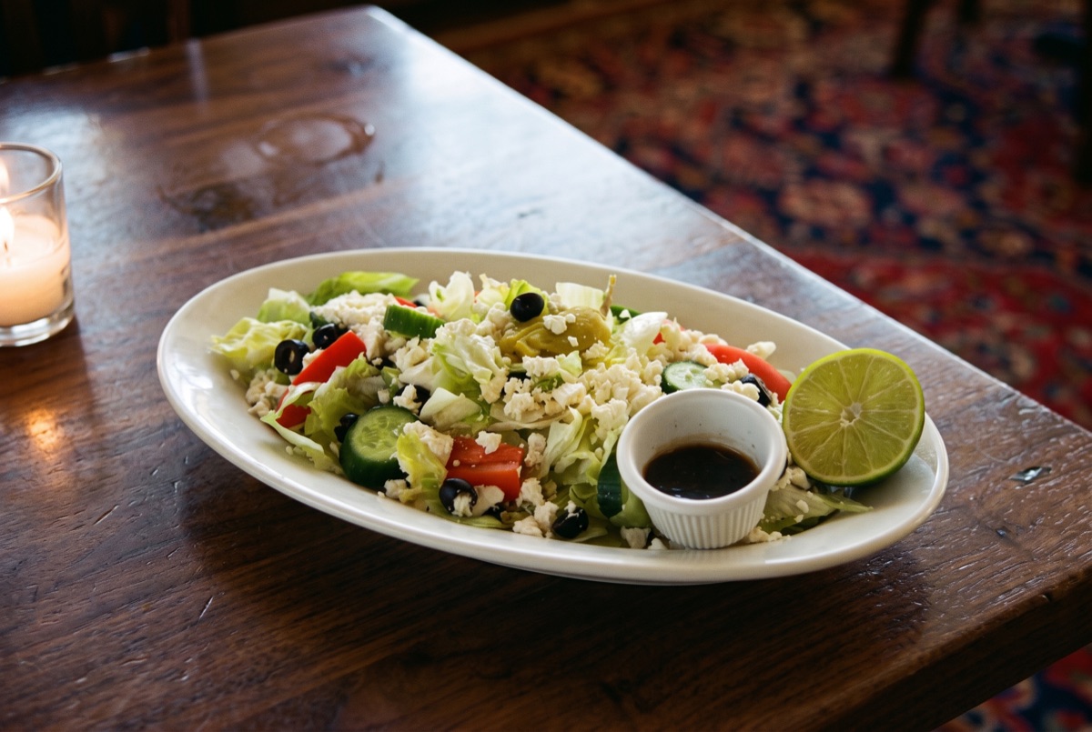 Greek Salad · Cucumber, tomato, red onion, kalamata olives, and feta tossed with olive oil and oregano, the Mediterranean classic.