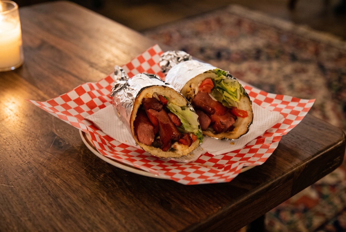 Hot Dog · A charcoal-grilled all-beef hot dog, snapped and smoky, tucked into a soft bun with classic toppings of choice.