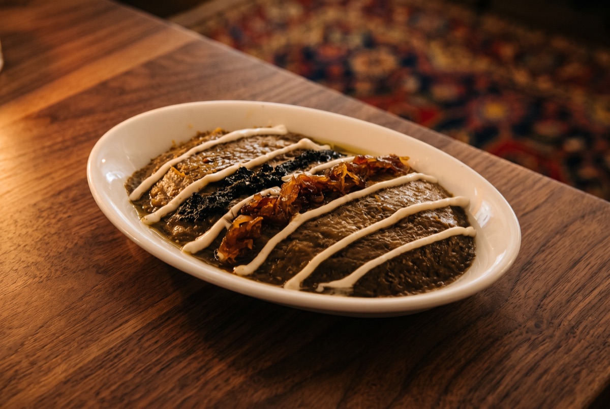 Kashk o Bademjoun (Eggplant Dish) · Caramelized, Onion and Kashk (Whey) served on bed of fried eggplant.