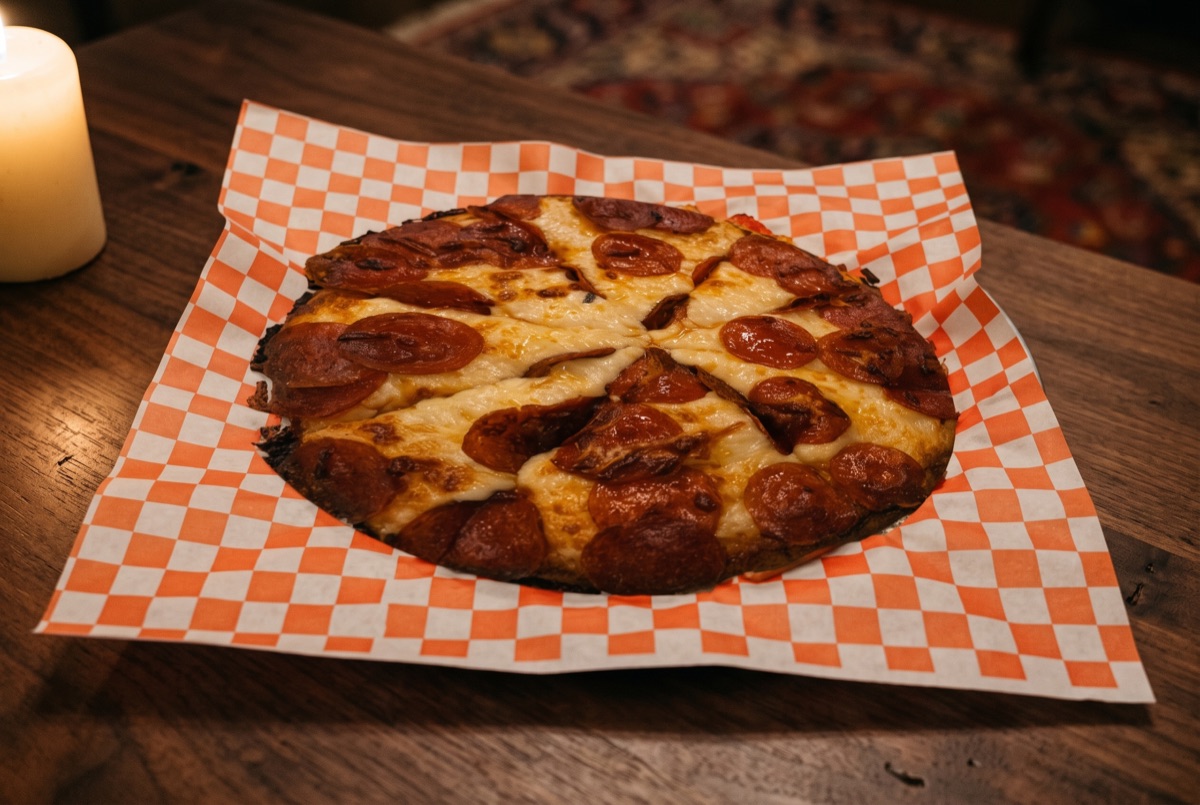 Pepperoni Pizza · Hand-stretched pizza dough layered with tomato sauce, melted mozzarella, and thin rounds of spiced…