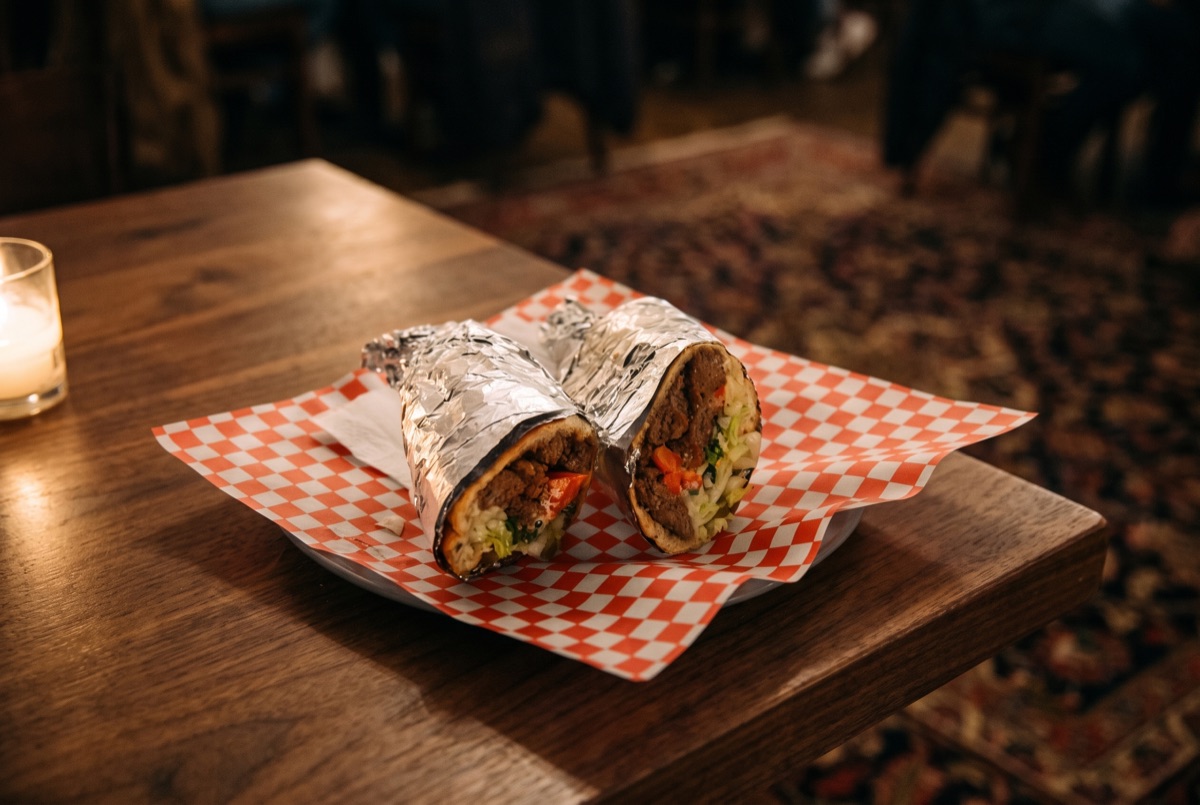 Persian Burger · A charcoal-grilled beef patty seasoned with saffron and onion in the Persian style, served on a soft bun with…